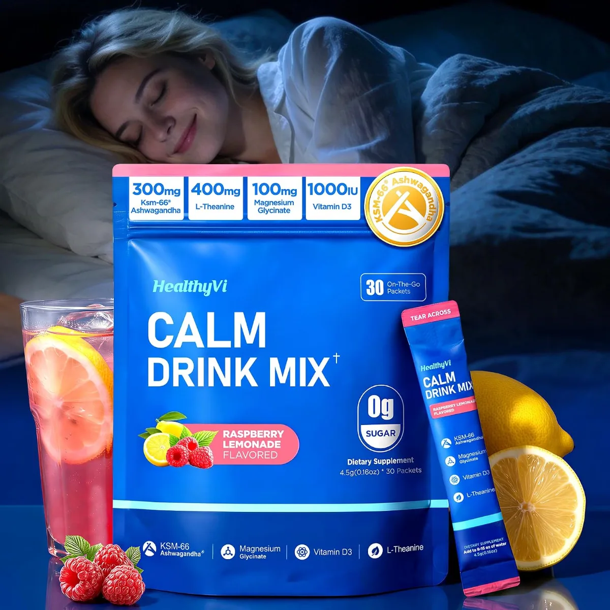 Close-up of Calm Magnesium Glycinate Powder in a glass with raspberry lemonade flavor, sitting on a nightstand beside a candle and journal for sleep and stress relief